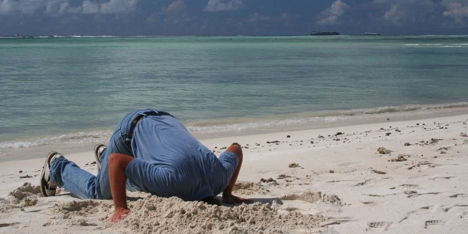 Disruption - Man with head in sand ignoring innovation